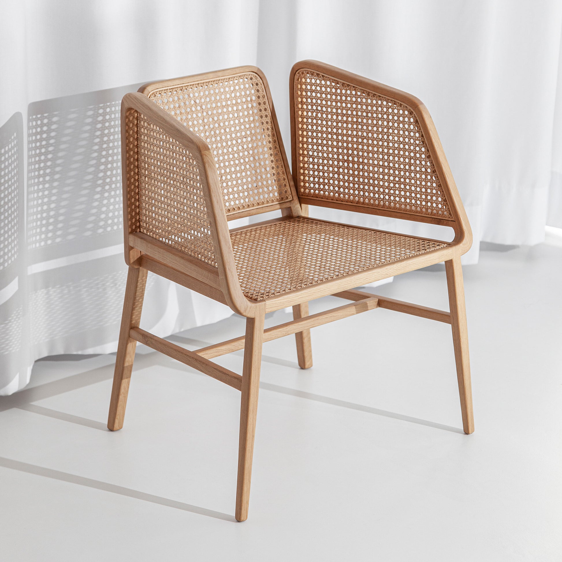 A cadeira Porventura Bee, com o seu design suave e curvo e pés em madeira, exibe uma estética moderna e elegante.