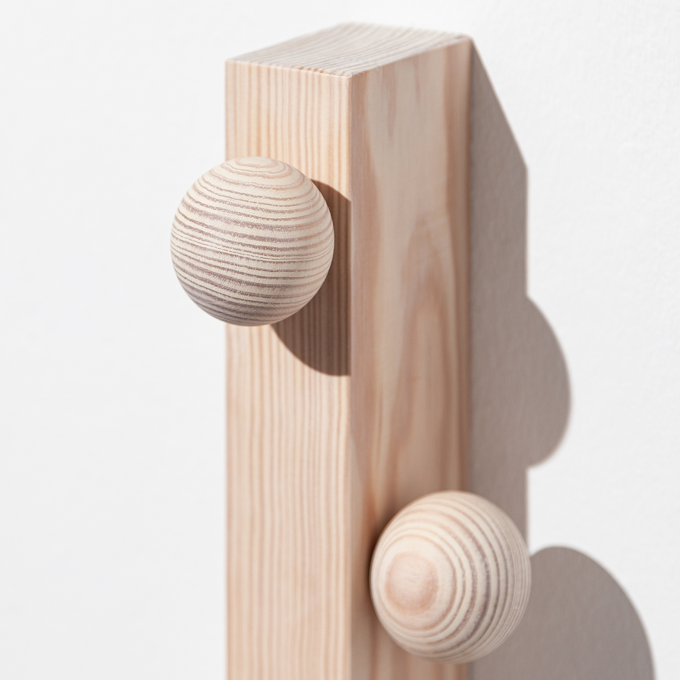 Solid wood hanger by João Xará with a sturdy, natural finish, designed for hanging garments in a stylish and durable way.