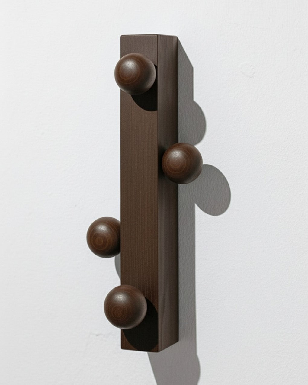 Wall hanger by João Xará, crafted from solid ash wood painted brown, offering a practical and distinctive solution for hanging coats and accessories.