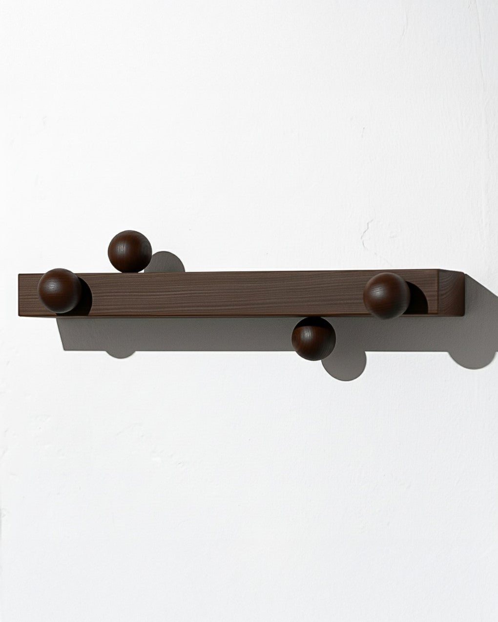 Solid wood hanger from João Xará, featuring a sturdy design and rich brown finish for hanging clothes.