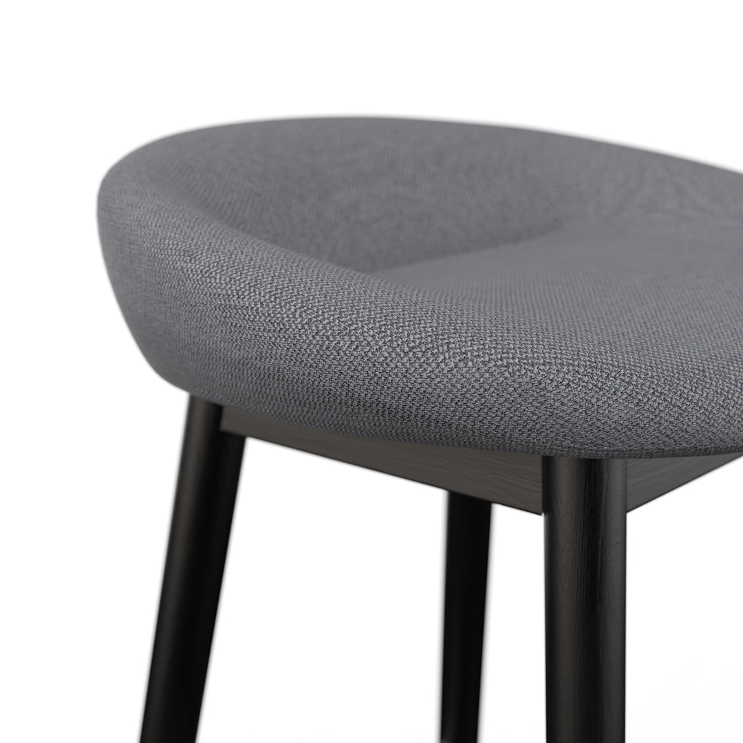 Porventura cake-shaped stools with black finish, showcasing modern design and comfortable seating for contemporary interiors.
