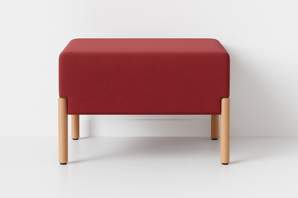 Porventura COD ottoman in red Camira fabric, featuring a square cushioned seat supported by beech wood legs, bringing colour and comfort to contemporary interiors.