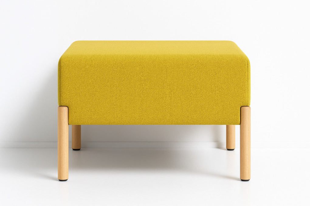 Porventura COD ottoman, pairing yellow Camira upholstery with beech wood legs. Its square cushioned form adds a warm touch of colour to contemporary living spaces.