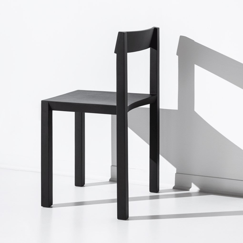 JBNG Studio FORMAL chair with sleek design, featuring a wooden seat and modern wooden legs for elegant dining use.