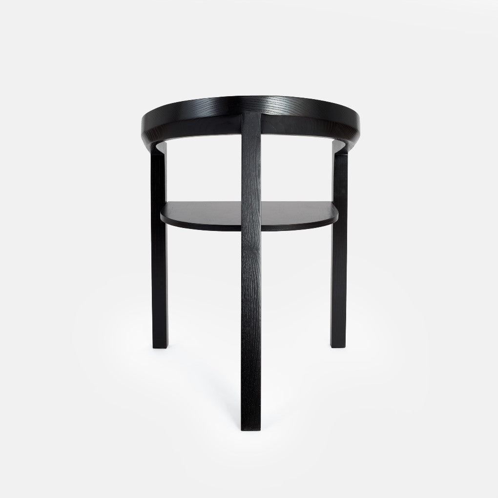Rear view of the ICON chair in black-painted ash, highlighting its distinctive backrest and clean, elegant lines.