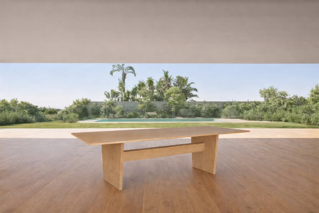 A dining table crafted in oak veneer, defined by a substantial rectangular top and solid block legs that give the piece a strong, architectural presence.