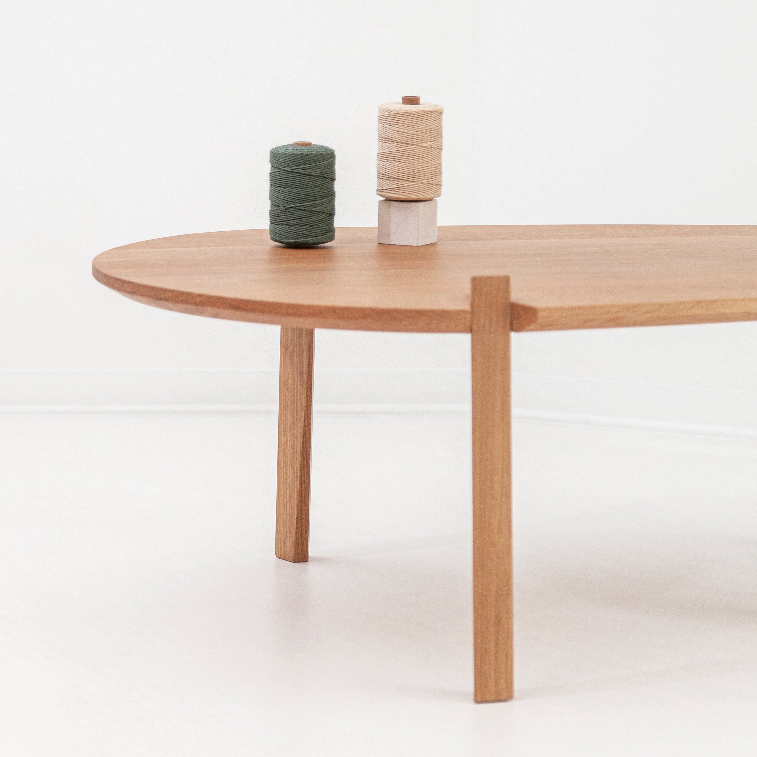 Modern Fenda coffee table by Cátia Moura featuring a sleek, minimalist design with a smooth wooden surface and sturdy legs.
