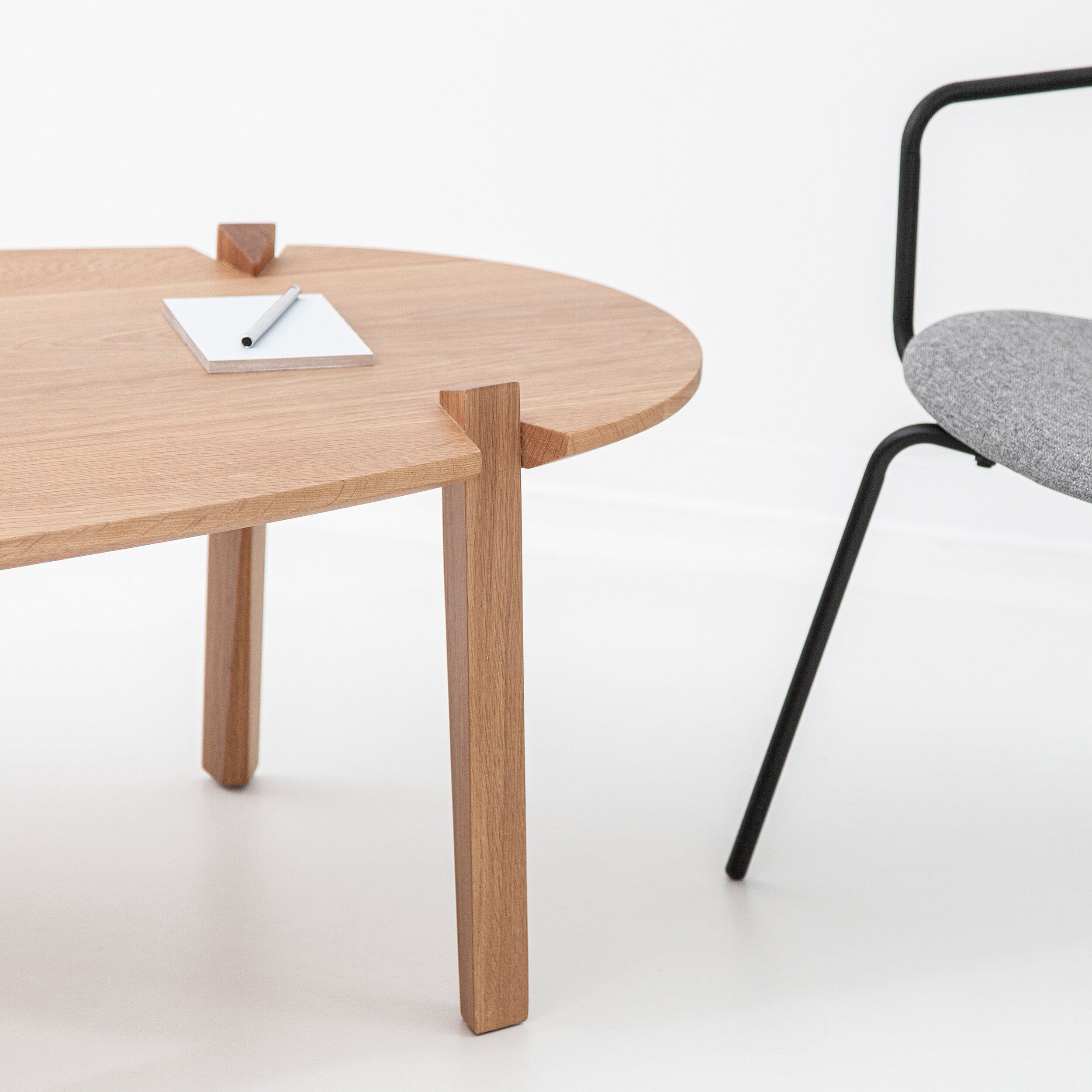Cátia Moura Fenda coffee table with a sleek wooden top and modern design, showcased in a well-lit living room setting.