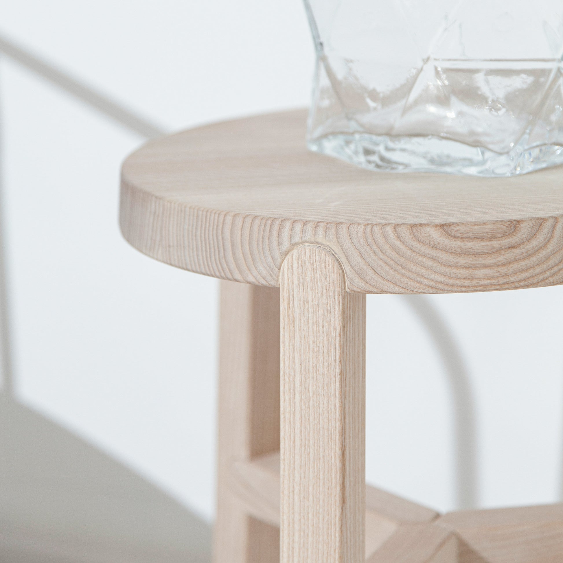 O banco Porventura Glyph, de Yiannis Ghikas, apresenta um design elegante e moderno com curvas suaves e uma base robusta.
