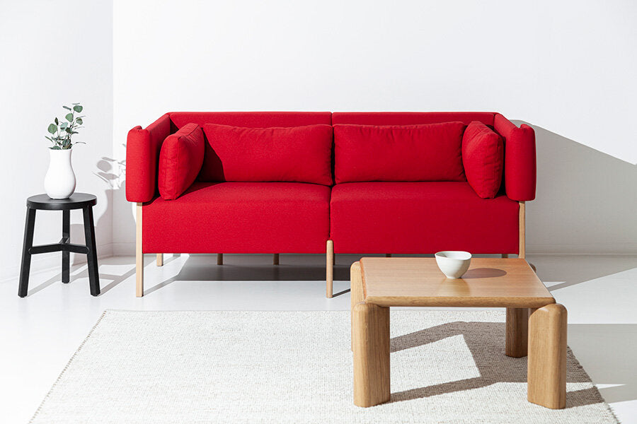 Porventura Cod three-seater sofa with plush fabric and wide armrests, shown in a cozy living room setting.