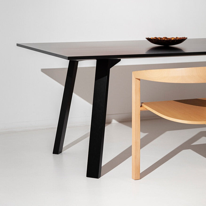 Mesa plana Porventura com um design elegante e moderno, apresentando uma superfície lisa e pés robustos, adequada para interiores contemporâneos.