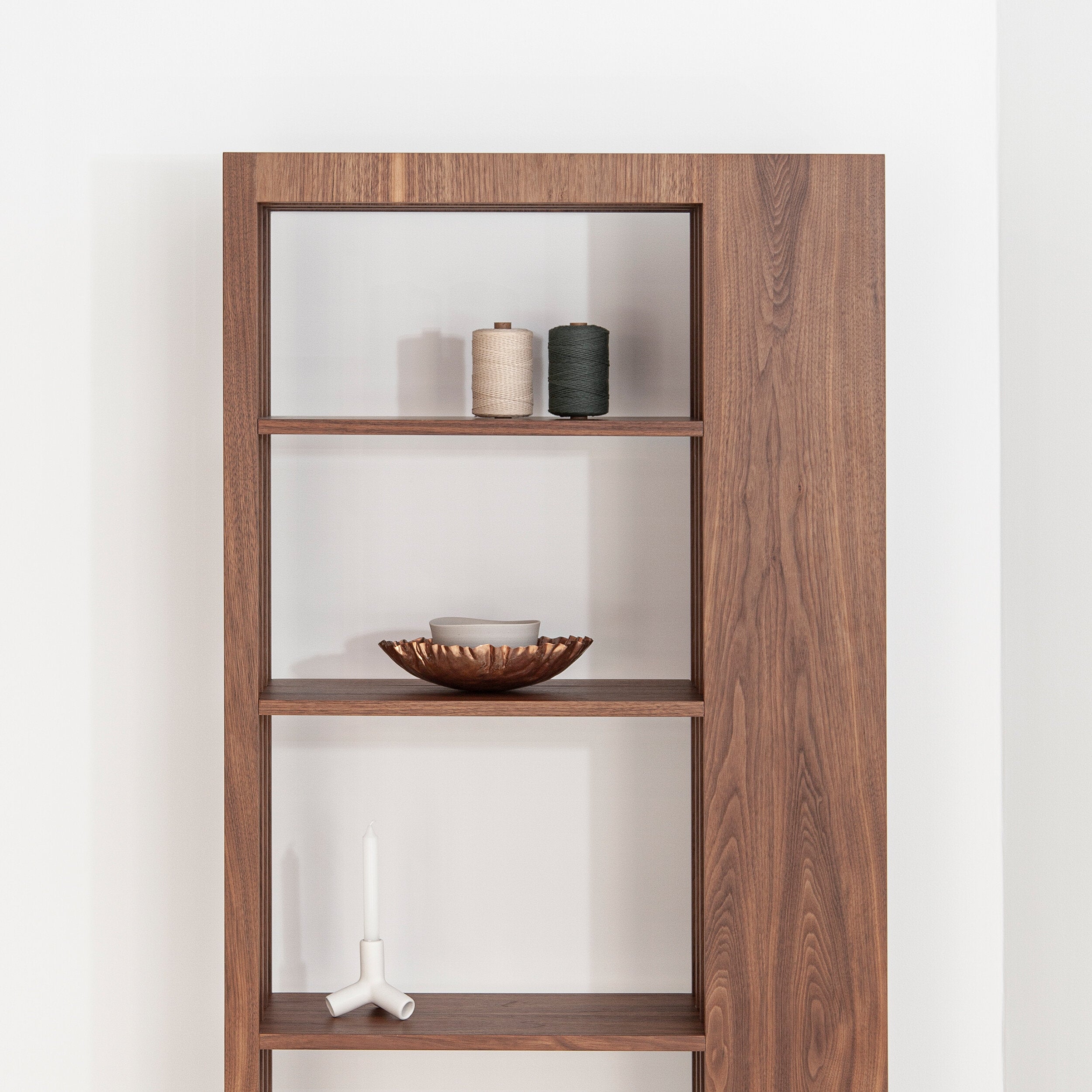 Porventura shelving unit with multiple horizontal metal rules, showcasing a modern storage solution in a minimalist design.