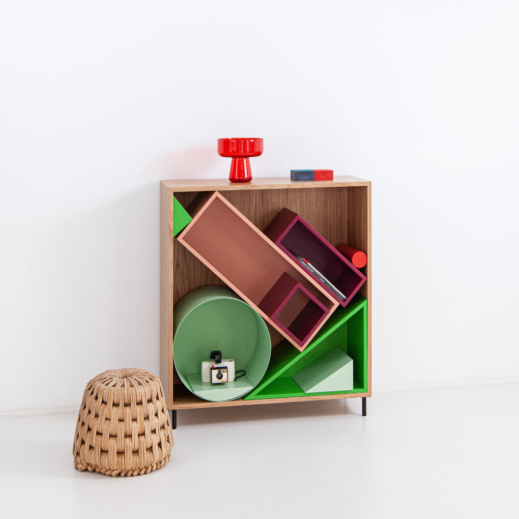 Porventura SANDBOX shelving unit is crafted in oak veneer with metal legs, featuring movable internal elements that can be repositioned to create different compositions and adapt the piece to individual storage and display needs.