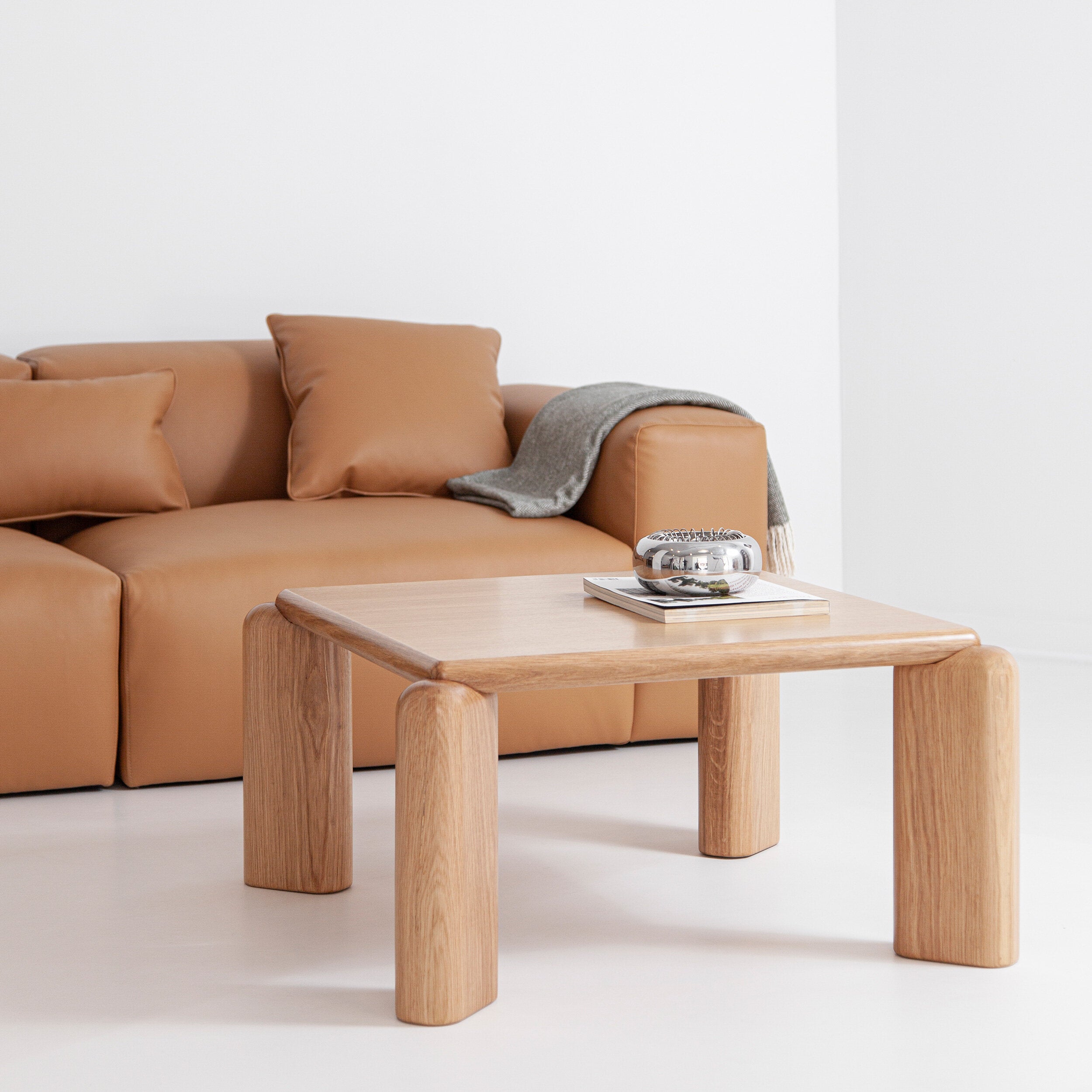 Porventura Soften coffee table with a sleek wooden top and minimalist design, shown in a modern living room setting.